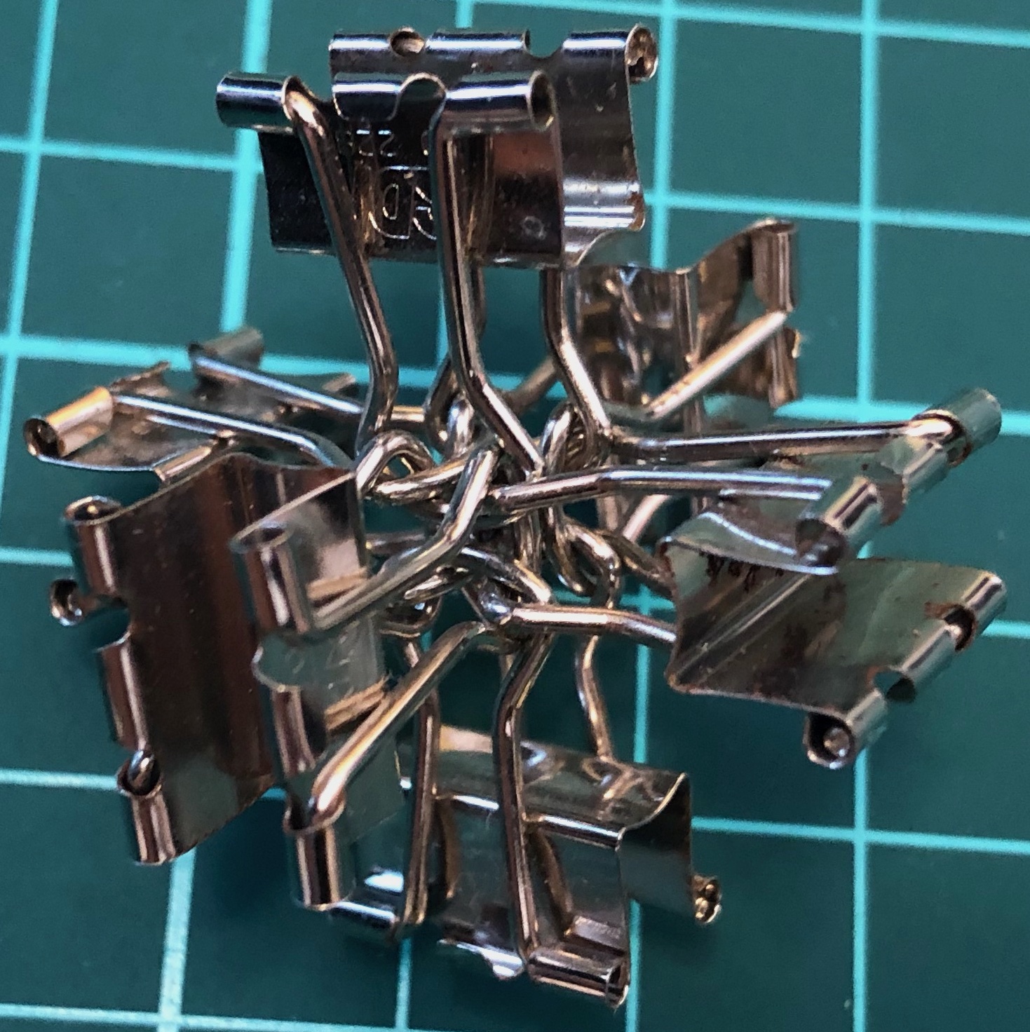 6 binder clips forming a 3D cross